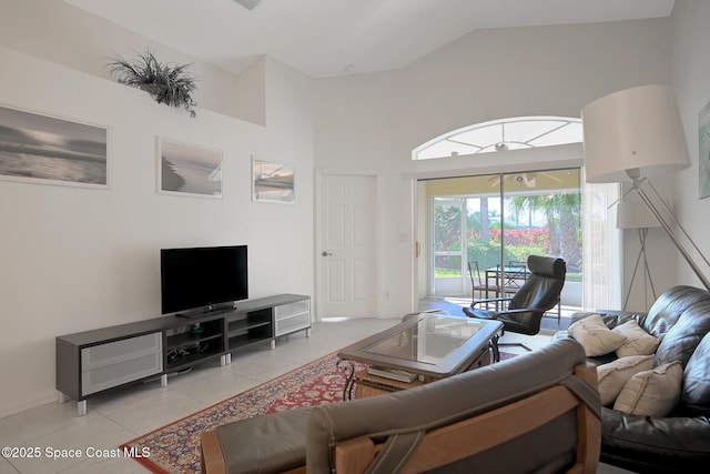 living room with high vaulted ceiling and light tile patterned floors