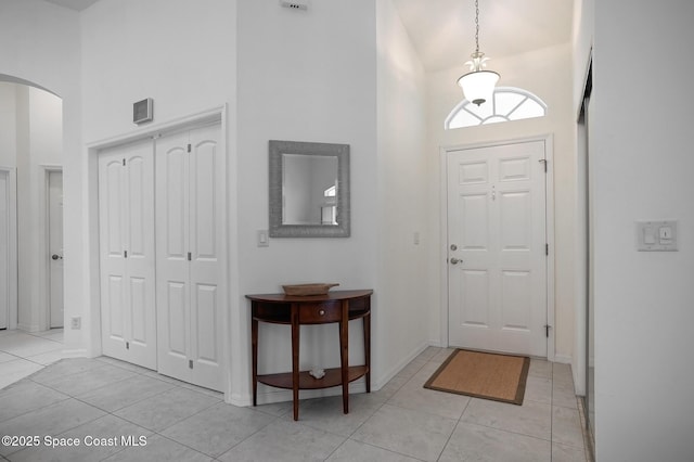 tiled foyer with high vaulted ceiling