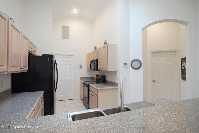 kitchen with sink, high vaulted ceiling, light tile patterned floors, light brown cabinets, and black appliances