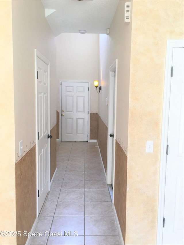 hallway featuring light tile patterned floors