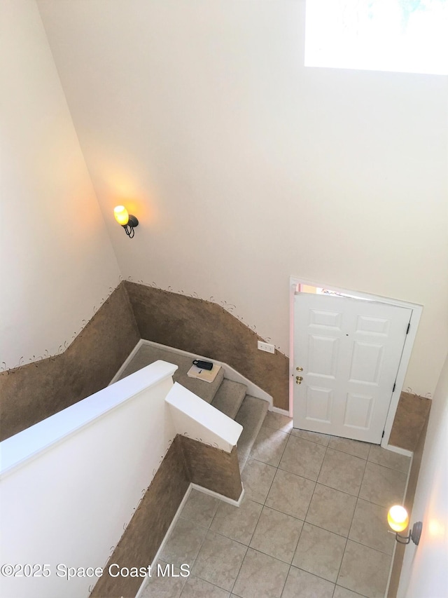 staircase featuring tile patterned floors