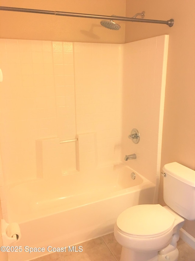 bathroom featuring shower / bathtub combination, toilet, and tile patterned flooring