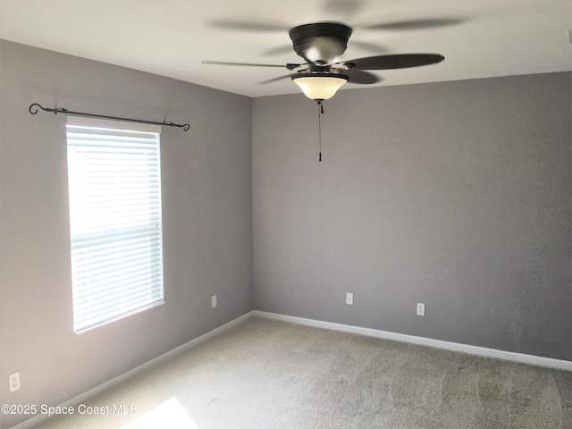 carpeted empty room with ceiling fan and a healthy amount of sunlight