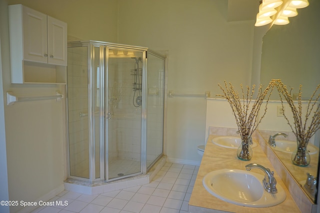 full bathroom featuring tile patterned flooring, a shower stall, double vanity, and a sink