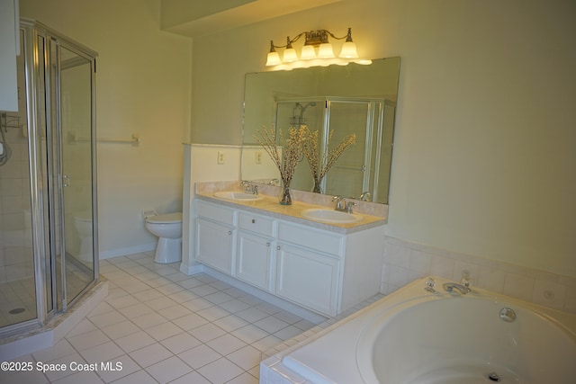 bathroom featuring a shower stall, toilet, a garden tub, and a sink