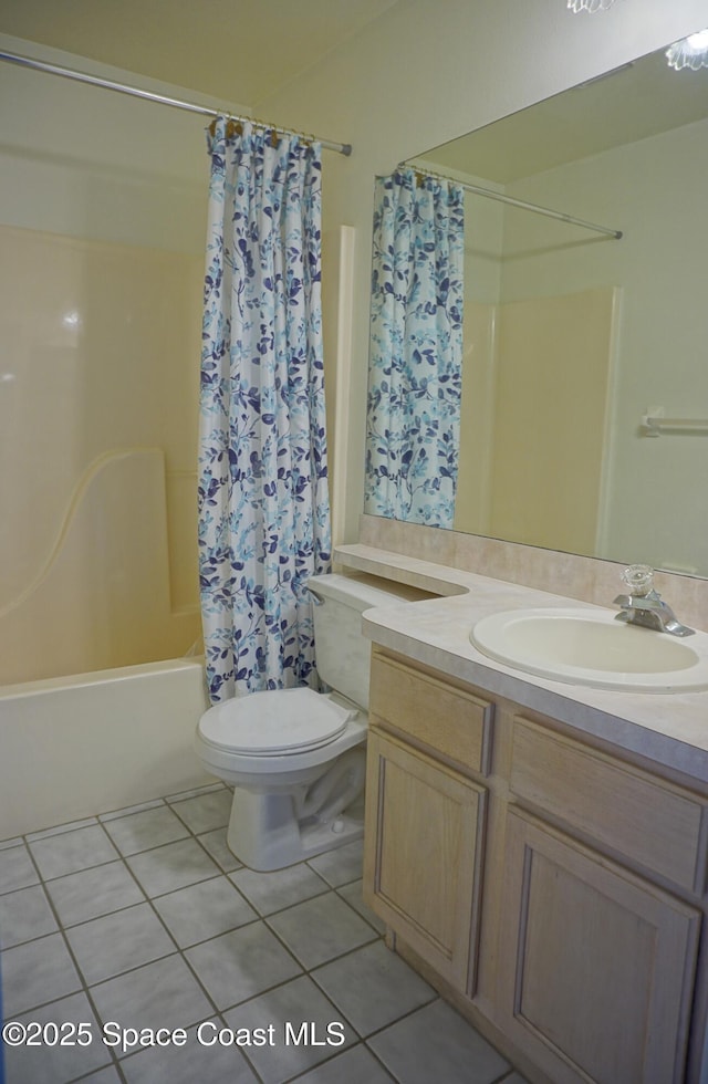 full bath featuring toilet, tile patterned floors, shower / bath combination with curtain, and vanity