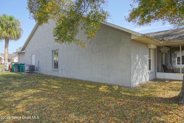 view of property exterior with stucco siding, a lawn, roof with shingles, and cooling unit