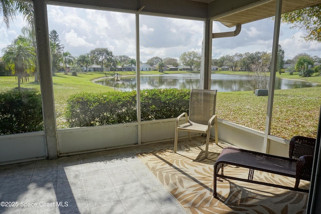 sunroom featuring plenty of natural light and a water view