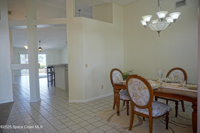 dining area featuring light tile patterned floors, visible vents, ceiling fan with notable chandelier, and baseboards