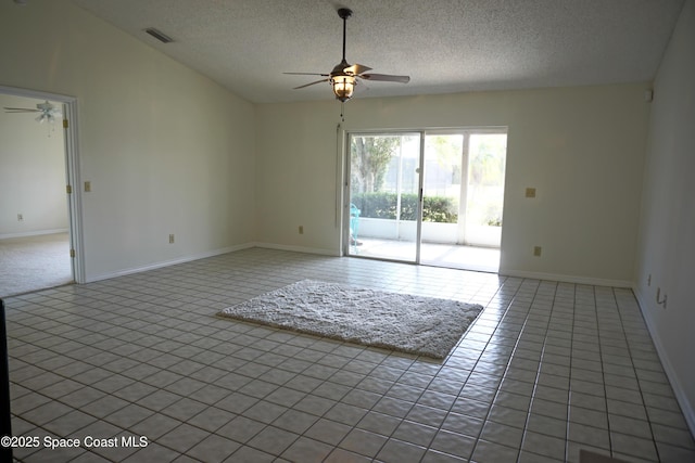 unfurnished room with visible vents, a ceiling fan, a textured ceiling, light tile patterned floors, and vaulted ceiling