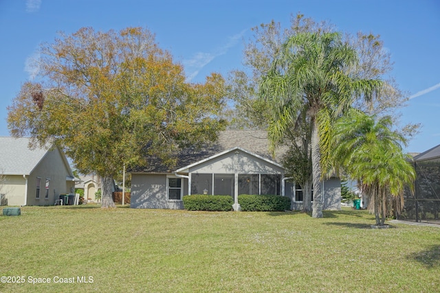 view of front of property featuring a front lawn and cooling unit