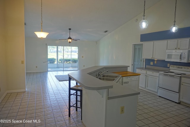 kitchen featuring white cabinetry, white appliances, an island with sink, and a sink