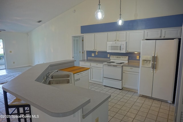 kitchen with white appliances, a kitchen island with sink, a sink, white cabinets, and a kitchen breakfast bar