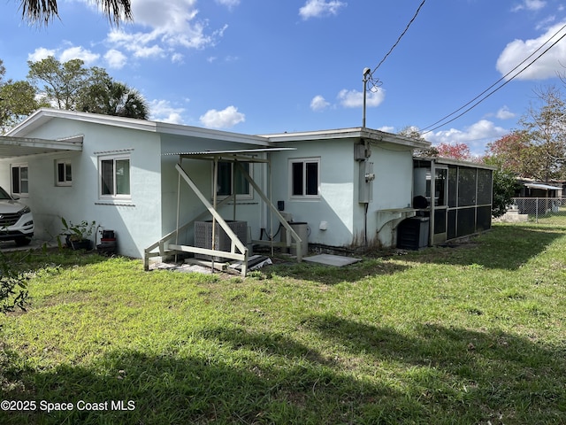 rear view of house with a yard and central AC