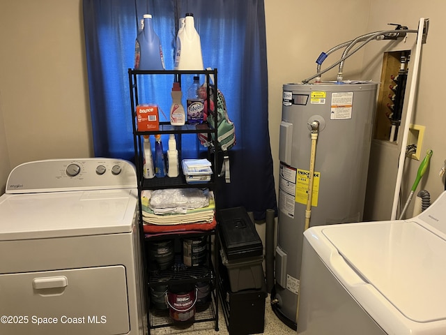 laundry room with water heater and washer and clothes dryer