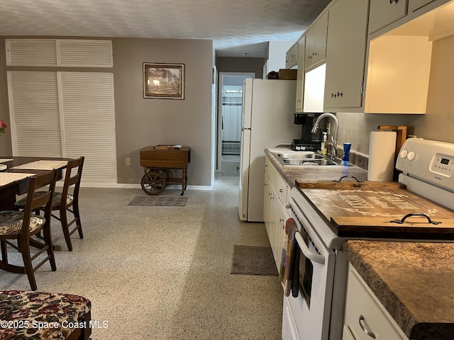 kitchen featuring white appliances, sink, and white cabinets