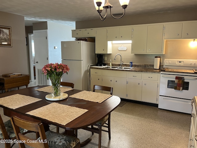 kitchen with sink, white appliances, and a notable chandelier