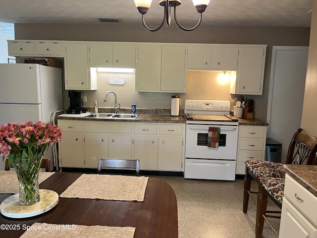 kitchen featuring a notable chandelier, sink, white cabinets, and white appliances