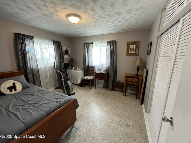 bedroom featuring a textured ceiling and a closet