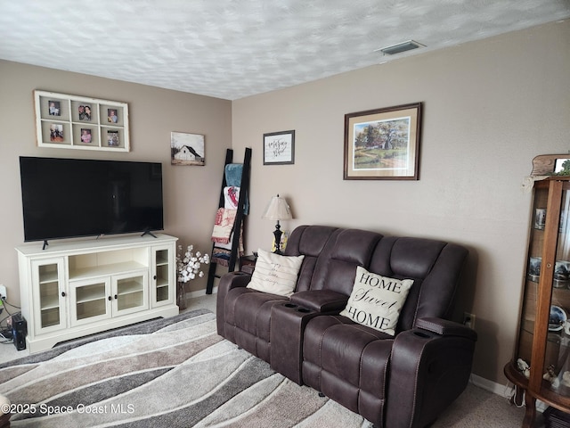 carpeted living room featuring a textured ceiling