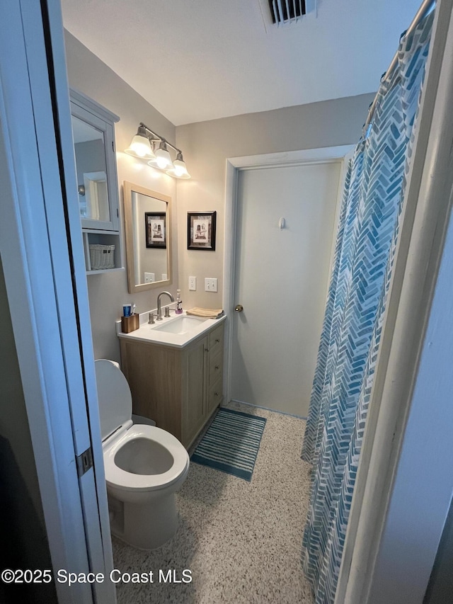 bathroom featuring vanity and toilet