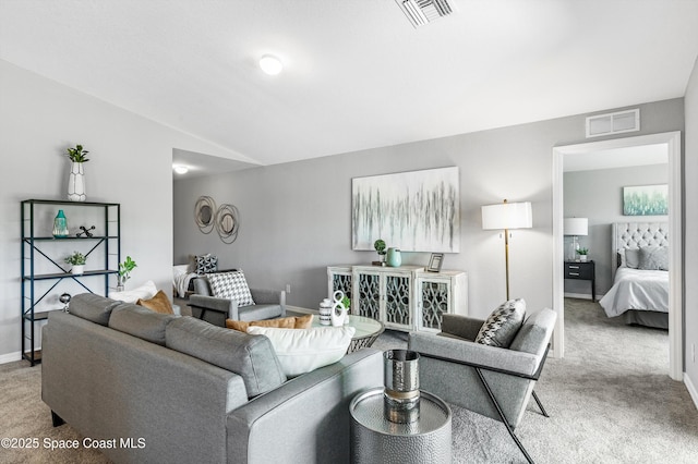 carpeted living room with lofted ceiling