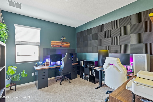 office area with a textured ceiling and carpet flooring