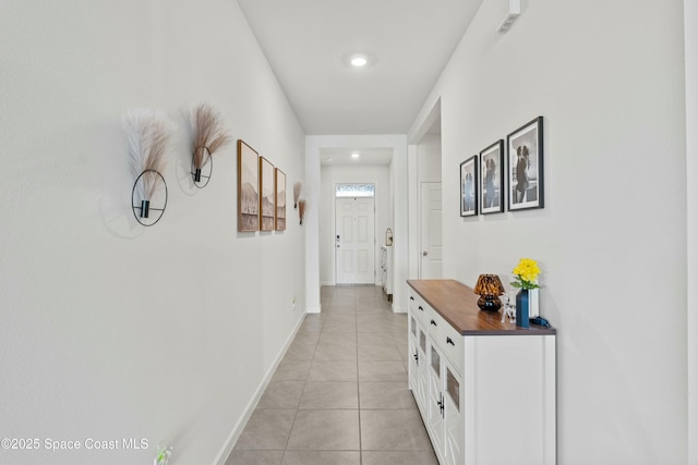 hall with light tile patterned floors