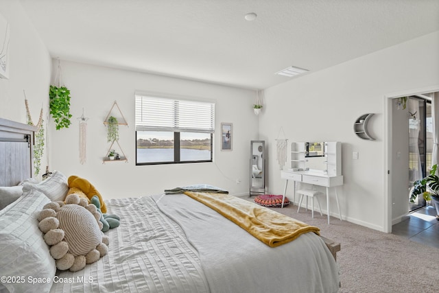 bedroom with carpet and a textured ceiling