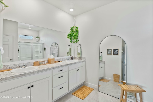 bathroom with vanity, tile patterned flooring, and a shower with door