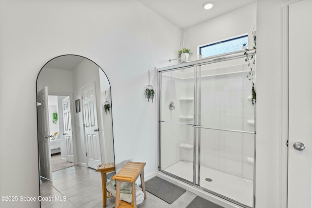 bathroom with a shower with door