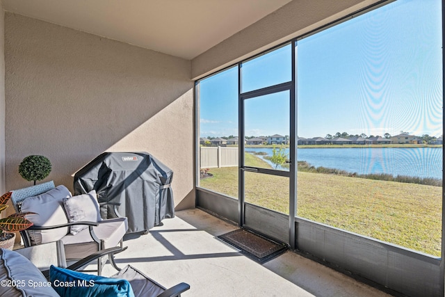 sunroom with a water view and a wealth of natural light