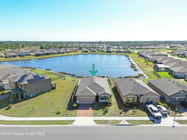 birds eye view of property with a water view