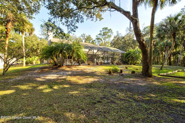 view of yard featuring a lanai