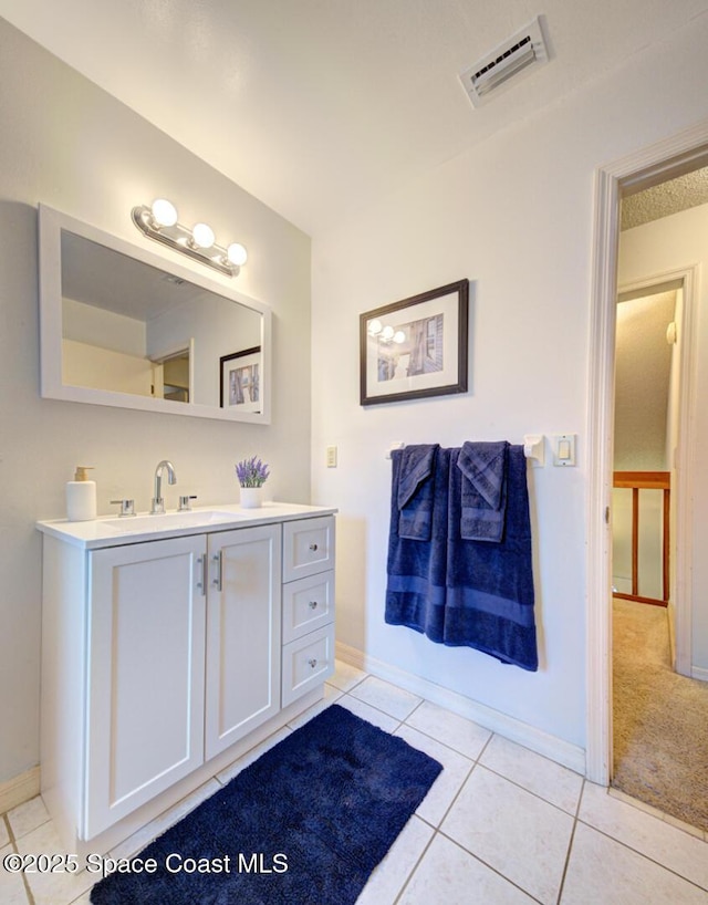 bathroom with tile patterned floors and vanity