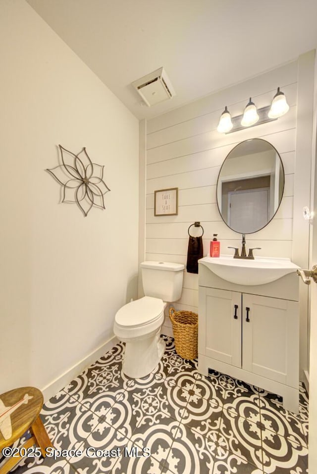 bathroom with vanity, tile patterned floors, and toilet