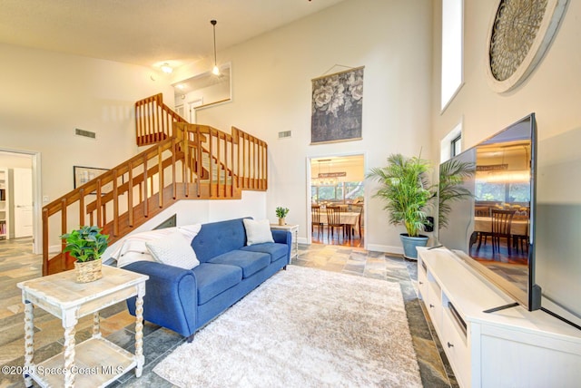 living room with a towering ceiling