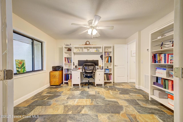 office space with ceiling fan and a textured ceiling