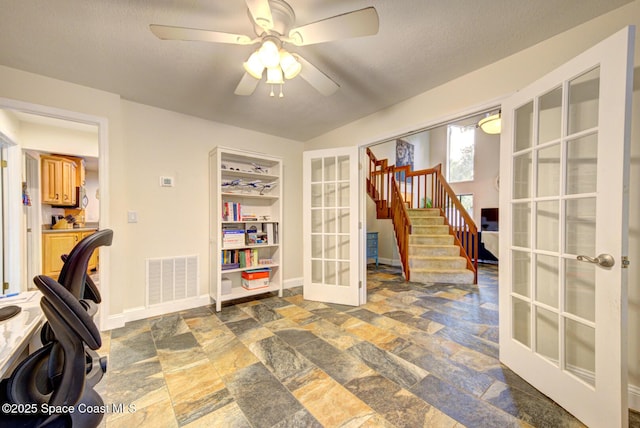 office space with ceiling fan, french doors, and a textured ceiling