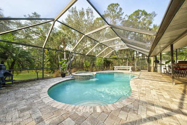 view of swimming pool with an in ground hot tub, a lanai, and a patio