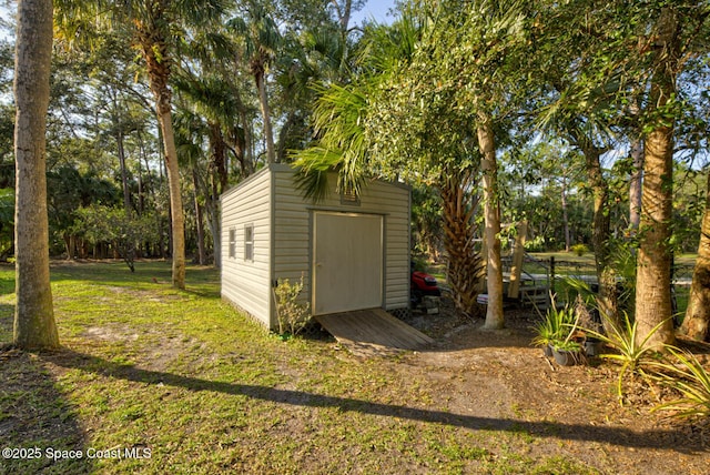 view of outbuilding with a lawn