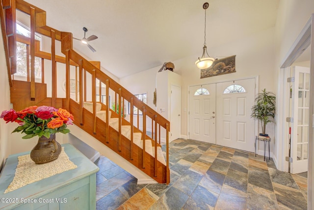 entryway featuring a towering ceiling and plenty of natural light