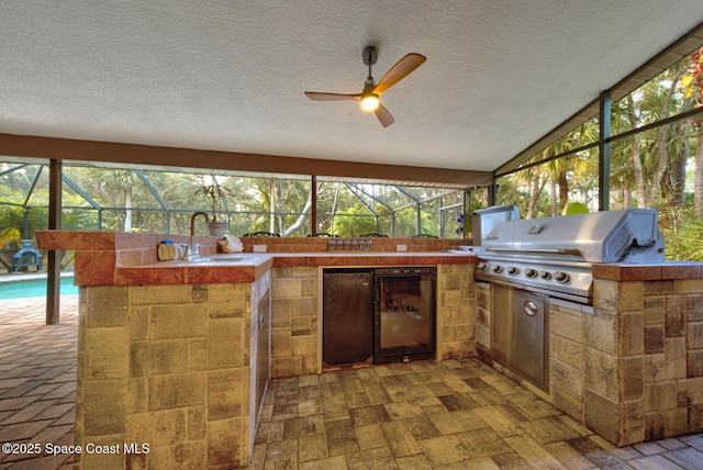 view of patio / terrace featuring exterior kitchen, area for grilling, and sink