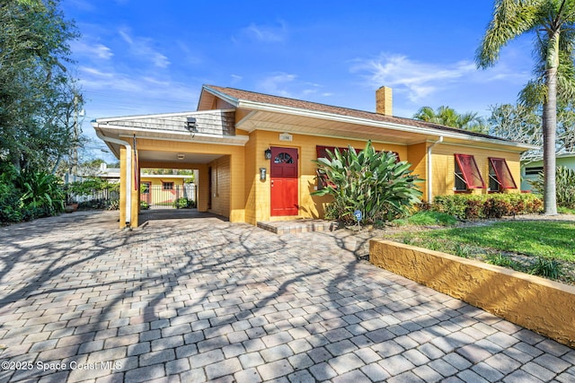 single story home with a carport