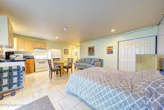 tiled bedroom featuring white fridge