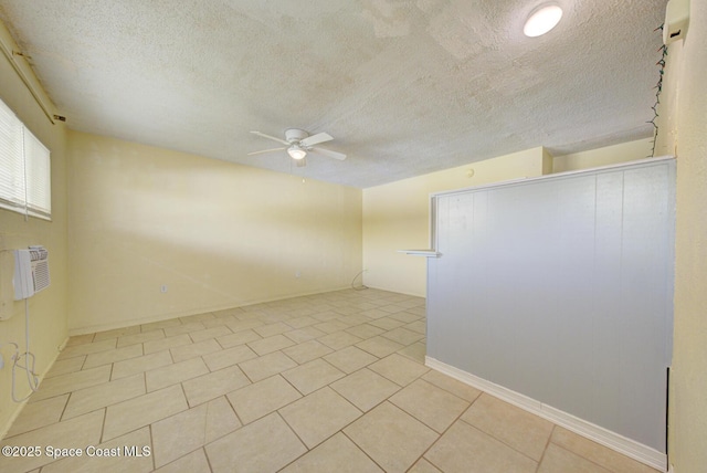 unfurnished room featuring light tile patterned floors, a textured ceiling, and ceiling fan