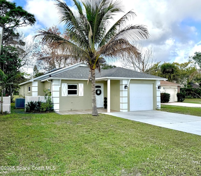 single story home with a garage and a front lawn