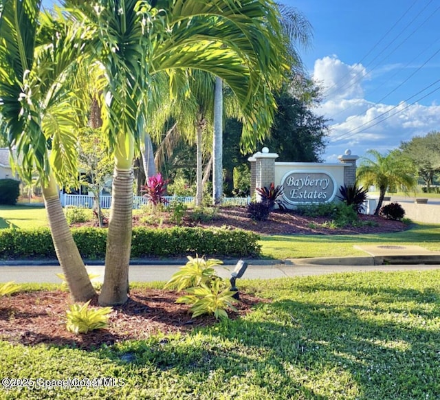 community sign featuring a lawn