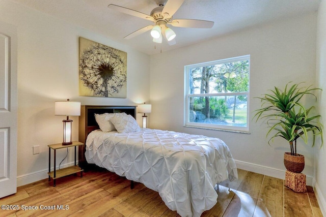 bedroom featuring hardwood / wood-style flooring and ceiling fan