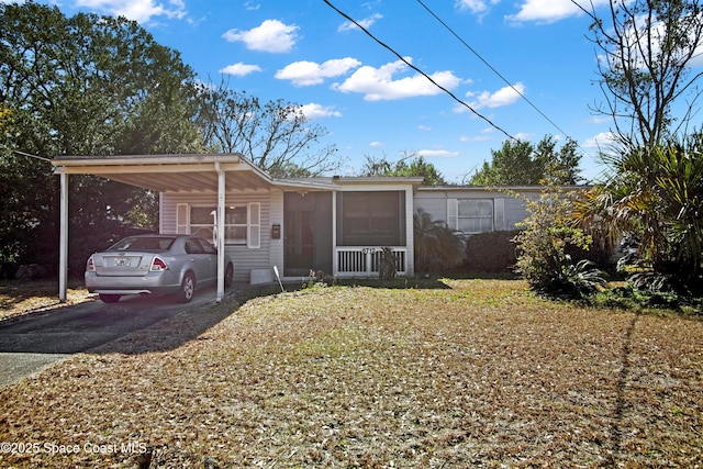 view of front facade with a front yard, a carport, and a porch